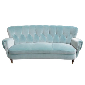 Scandinavian retro sofa upholstered in a blue velvet fabric